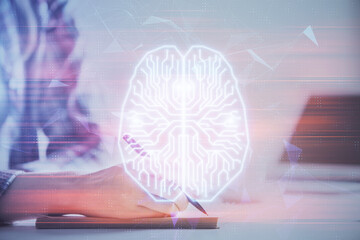 Multi exposure of woman's writing hand on background with brain hud. Concept of learning.