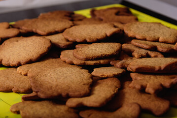 Decorating freshly baked cookies with icing. Christmas and New Year celebration traditions, festive sweets, family culinary. Traditional gingerbread. 