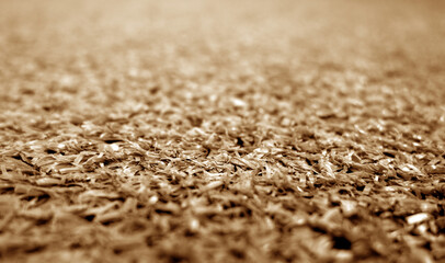 brown color artificial grass close-up with blur background