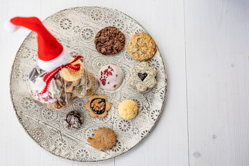 Close up of christmas cakes and cookies with santa hat 