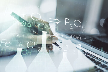 Creative chemistry concept with hand writing in notebook on background with laptop. Multiexposure