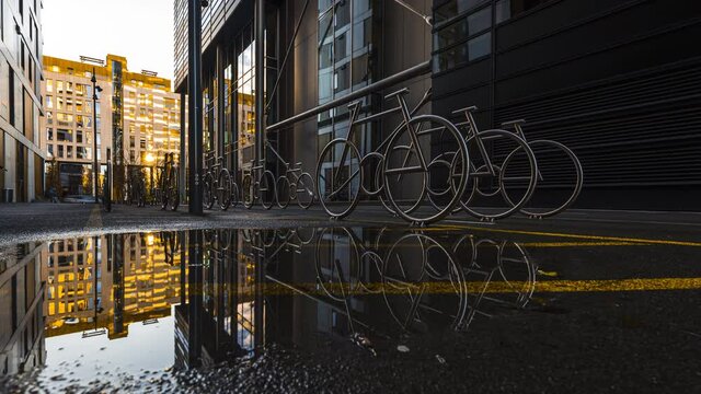 Bicycle Racks On Wet Alley At The Barcode Project In Oslo, Norway At Daytime - low level, time lapse