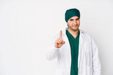 Young surgeon man isolated on white background showing number one with finger.