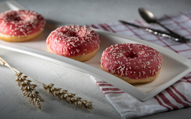 
Pink donuts on a white plate