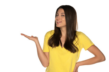 young beautiful woman holding imaginary object on her hand