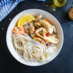 rice noodles cellophane pasta seafood shrimp, mussels, squid healthy meal snack top view copy space for text food background rustic