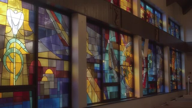 A wall of beautiful stained glass in a catholic church
