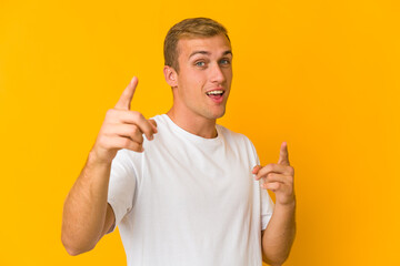 Young caucasian handsome man pointing to front with fingers.