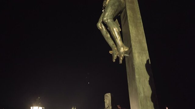 Statue of Jesus on the cross on Charles bridge at night,Prague,Czechia.