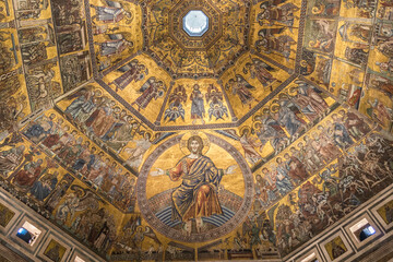 Fototapeta na wymiar Christ Pantocrator. A Christian icon derived from one of many names of God in Judaism. A mosaic on the ceiling of a dome over golden background.