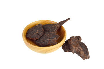 He Shou Wu Fo-Ti Dry Root (Polygonum Multiflorum)in a Wooden Bowl. Isolated on White.