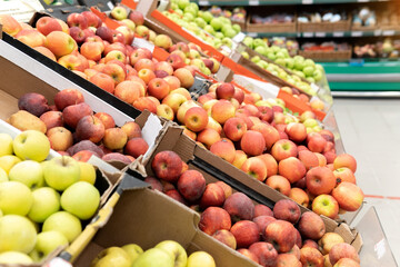 apples in supermarket. Apple put on sale shelves in the supermarket.