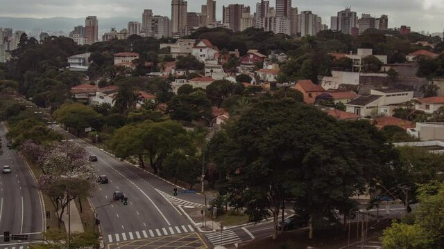 Hyperlapse, wide shot of Sao Paulo west zone at Sumare Avenue, with traffic, houses and buildins in the background, Brazil.