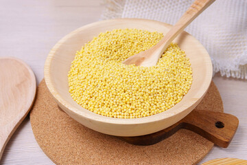 Raw millet groats on wooden background. space for text