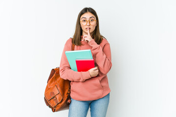 Young student woman isolated on white bakcground keeping a secret or asking for silence.