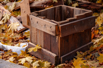 Autumn decor in the garden. Wooden box on autumn background. Autumn time.