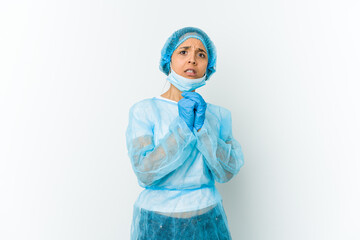 Young surgeon latin woman isolated on white background scared and afraid.