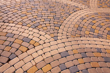 Cobblestone arched pavement road, paving in cobblestones in a square.