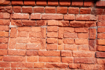 Closeup of ancient old red brick wall texture or background
