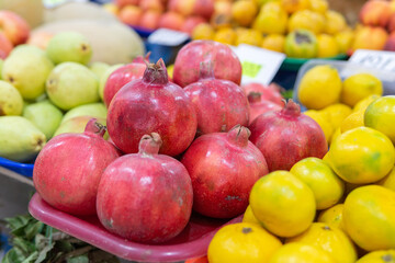 Pomegranate fruits close-up kept for sale in the street of market. selective focus