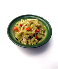 Spicy stir fried chayote or tumis labu siam is typical Indonesian home dish. Made from slices of chayote, seasoning with garlic and onion. Some love to add mushroom. Serve in enamel bowl. Isolated.
