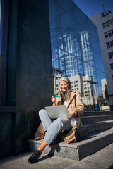 Obraz na płótnie Canvas Joyful woman with credit card using laptops for online shopping