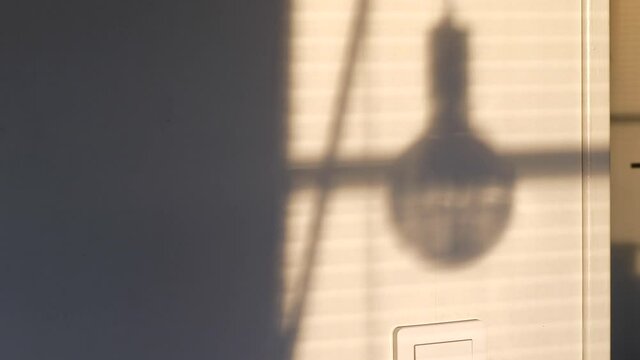 Time lapse of window sunshine and shadow of lamp moving on living room wall