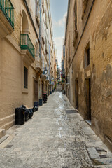 Narrow street leading to some steps in Valletta the capital city of Malta. - 395301934