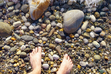 feet on the beach on the beach with rocks and pebbles