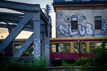train passing a graffiti wall in an urban surrounding