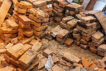piles of brick, Red brick for building houses. Many used wall bricks laid on a pile