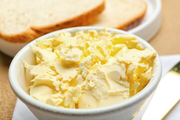 Plate with fresh butter on table