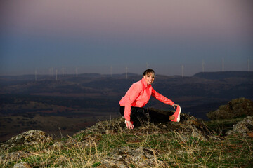 Young sheltered woman doing some stretching exercises