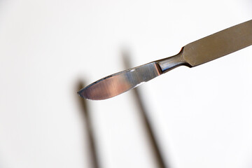 Surgery blade on the sterile table, scalpel close-up, operation equipment