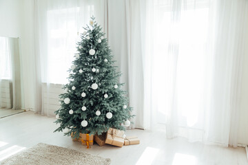 New Year's decoration Christmas tree with gifts and garlands interior