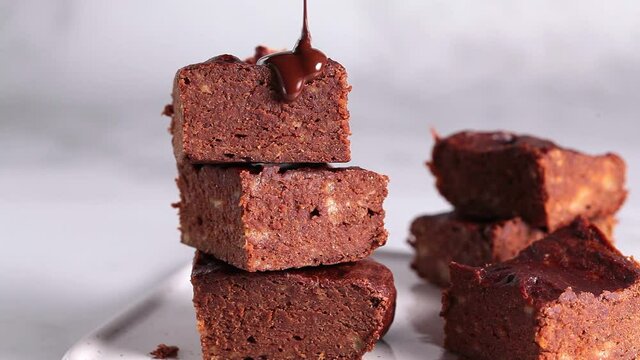 Vegan brownie pours dark chocolate. Vegan dessert concept.