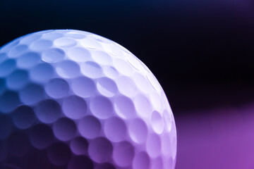 golf ball seen very close. Black background