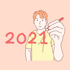 Man holding pen and writing 2021 in new year concept.