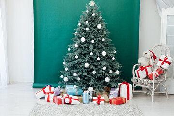 New Year's holiday Christmas tree decor with gifts and interior garlands