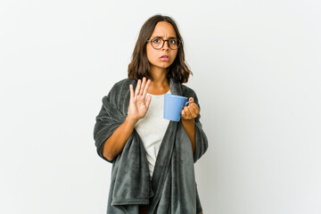Young latin woman with blanket isolated on white background