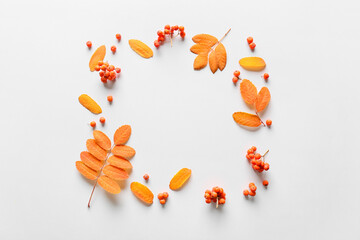 Frame made of autumn leaves on white background