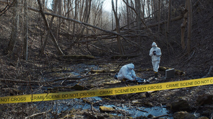 Detectives are collecting evidence in a crime scene. Forensic specialists are making expertise....