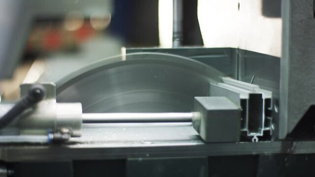 Buzzsaw cutting automatically metal profile in big warehouse/workshop 4k PRORES Footage