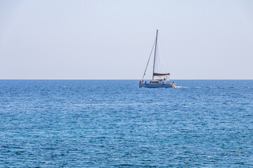 Fototapeta premium People sailing by Santorini sea