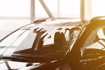 Black Car In Foam On A Car Wash