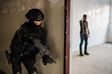 Man reenacting special unit of Croatian military police. Wearing green jumpsuit with black add-ons and assault rifle G36.