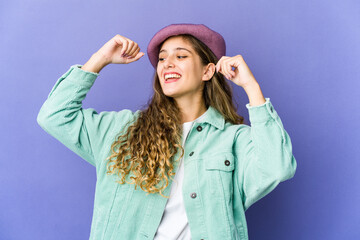 Naklejka premium Young caucasian cute woman celebrating a special day, jumps and raise arms with energy.