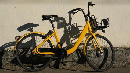 Fototapeta na wymiar The yellow bike in sharing project. bicycles of the urban bike-sharing to move into ecologically city. 