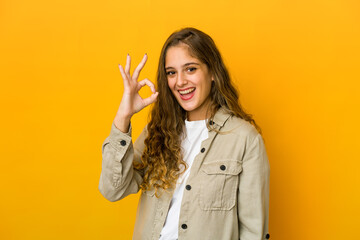 Young caucasian woman cheerful and confident showing ok gesture.