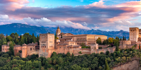 Palace and fortress complex Alhambra with Comares Tower, Palacios Nazaries and Palace of Charles V during sunset in Granada, Andalusia, Spain - obrazy, fototapety, plakaty